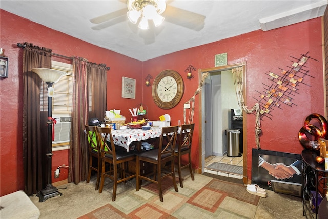 1054 14th St, Des Moines, IA 50314 - carpeted dining area with ceiling fan, a textured wall, and cooling unit