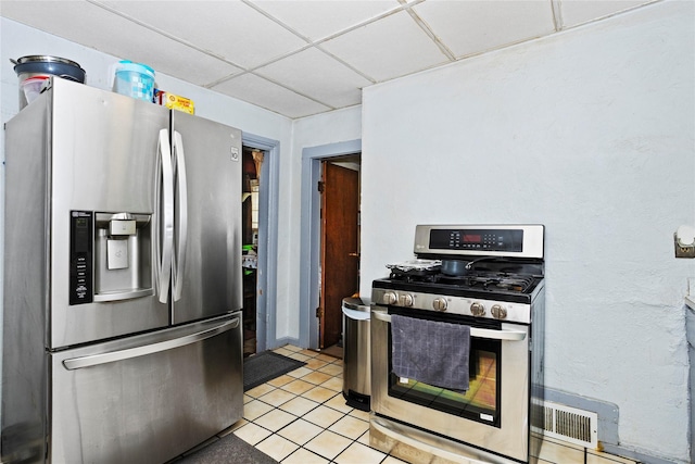1054 14th St, Des Moines, IA 50314 - kitchen with stainless steel appliances, a paneled ceiling, and light tile patterned flooring
