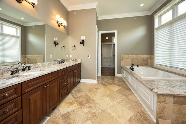 4701 150th St, Urbandale, IA 50323 - bathroom featuring a garden tub, double vanity, stone tile floors, crown molding, and a shower with door
