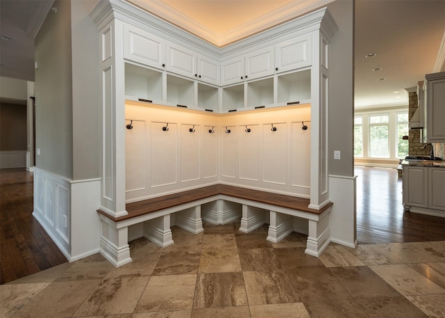 4701 150th St, Urbandale, IA 50323 - mudroom with a decorative wall, stone tile flooring, crown molding, and wainscoting