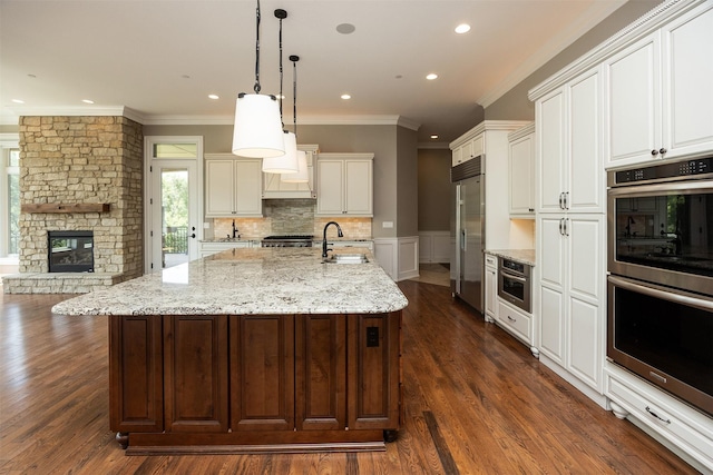 4701 150th St, Urbandale, IA 50323 - kitchen featuring stainless steel appliances, ornamental molding, recessed lighting, white cabinets, and wainscoting