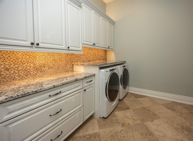 4701 150th St, Urbandale, IA 50323 - laundry area featuring washer and dryer, cabinet space, and stone finish floors