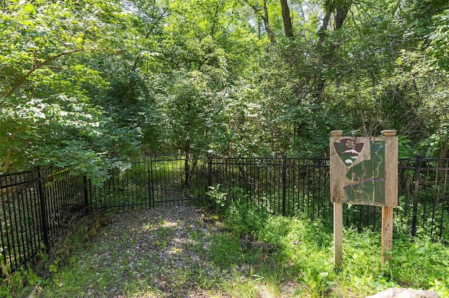 4701 150th St, Urbandale, IA 50323 - gate featuring a forest view
