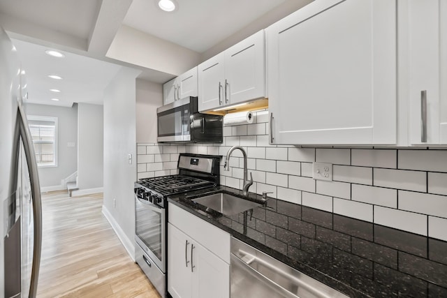 402 S 11th St, Adel, IA 50003 - kitchen featuring stainless steel appliances, dark stone countertops, tasteful backsplash, white cabinets, and recessed lighting