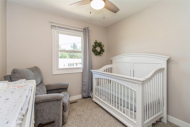 311 W 15th St N, Newton, IA 50208 - bedroom with light carpet, a nursery area, and a ceiling fan