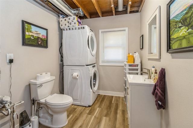 311 W 15th St N, Newton, IA 50208 - bathroom featuring stacked washing machine and dryer, vanity, and wood finished floors