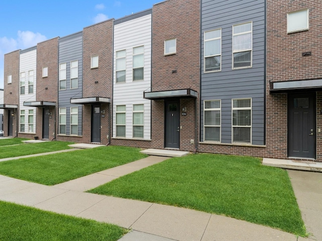 316 SW 6th St Unit 106, Des Moines, IA 50309 - view of front of home featuring a front lawn and brick siding