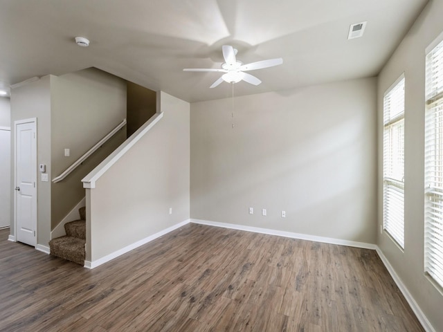 316 SW 6th St Unit 106, Des Moines, IA 50309 - unfurnished room featuring a ceiling fan, wood finished floors, stairs, and a smoke detector