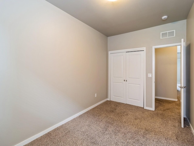 316 SW 6th St Unit 106, Des Moines, IA 50309 - unfurnished bedroom featuring carpet floors and a closet