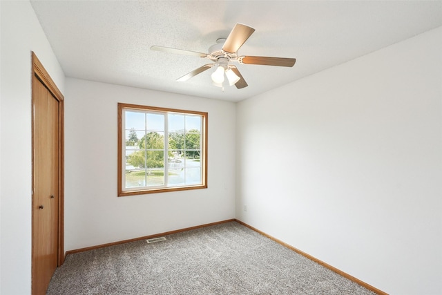 2907 E 43rd St, Des Moines, IA 50317 - unfurnished bedroom featuring a closet, light carpet, and a ceiling fan