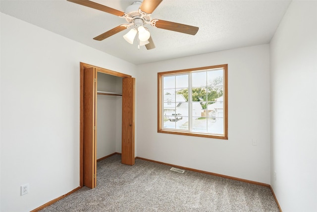 2907 E 43rd St, Des Moines, IA 50317 - unfurnished bedroom with light colored carpet, a closet, and ceiling fan