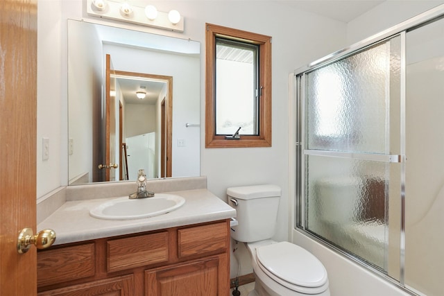 2907 E 43rd St, Des Moines, IA 50317 - bathroom with vanity and shower / bath combination with glass door