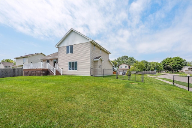 2907 E 43rd St, Des Moines, IA 50317 - rear view of property with a fenced backyard, stairway, a deck, and a gate