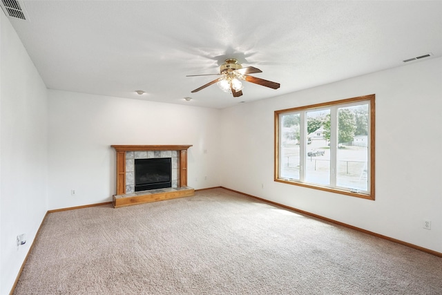 2907 E 43rd St, Des Moines, IA 50317 - unfurnished living room featuring carpet floors, ceiling fan, and a tiled fireplace