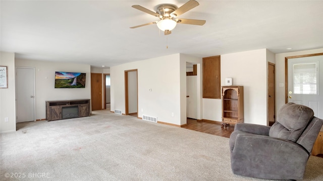 808 E 8th St S, Newton, IA 50208 - carpeted living room featuring ceiling fan and healthy amount of natural light