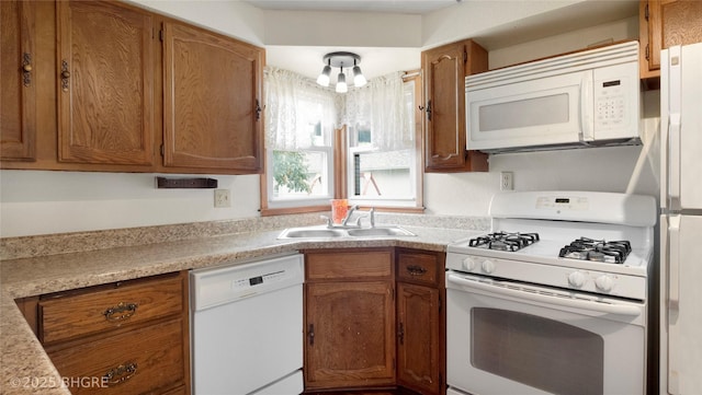 808 E 8th St S, Newton, IA 50208 - kitchen featuring white appliances, light countertops, and brown cabinets