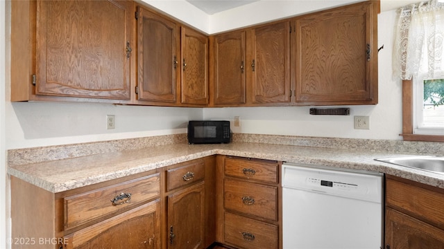 808 E 8th St S, Newton, IA 50208 - kitchen featuring dishwasher, black microwave, light countertops, and brown cabinets