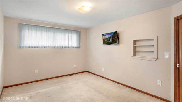 808 E 8th St S, Newton, IA 50208 - carpeted empty room with baseboards and built in shelves