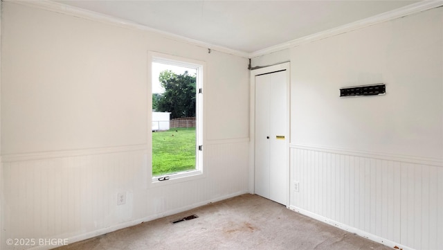 808 E 8th St S, Newton, IA 50208 - carpeted spare room featuring a wainscoted wall, healthy amount of natural light, and ornamental molding