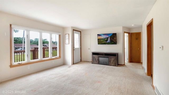 808 E 8th St S, Newton, IA 50208 - unfurnished living room with carpet and baseboards