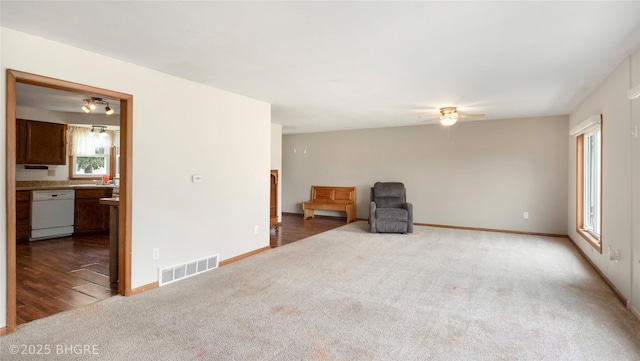 808 E 8th St S, Newton, IA 50208 - unfurnished living room featuring carpet floors and a ceiling fan