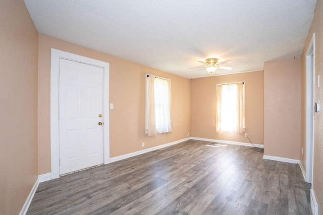 1421 N 4th Ave E, Newton, IA 50208 - empty room with dark wood-style flooring, ceiling fan, and a textured ceiling