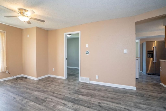 1421 N 4th Ave E, Newton, IA 50208 - unfurnished room featuring ceiling fan, wood finished floors, and a textured ceiling