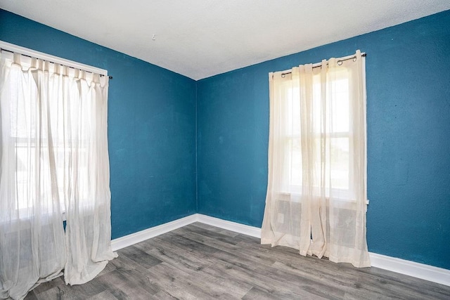 1421 N 4th Ave E, Newton, IA 50208 - unfurnished room with wood finished floors and baseboards