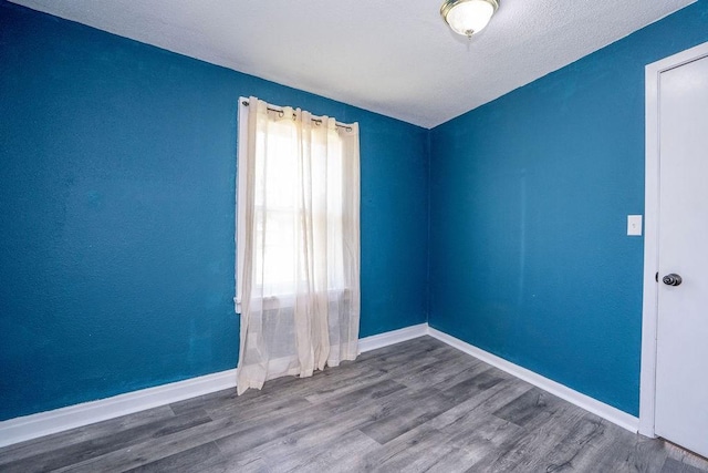 1421 N 4th Ave E, Newton, IA 50208 - spare room with wood finished floors and vaulted ceiling