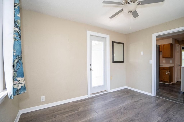 1421 N 4th Ave E, Newton, IA 50208 - unfurnished room with dark wood-type flooring and ceiling fan