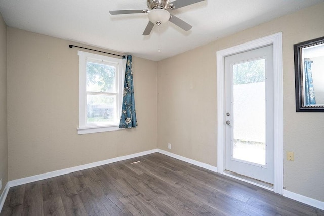 1421 N 4th Ave E, Newton, IA 50208 - empty room featuring plenty of natural light, dark wood-style flooring, and a ceiling fan