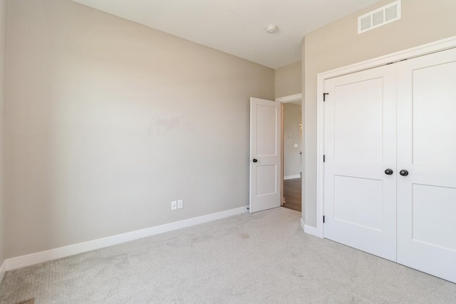 1809 12th St SE, Altoona, IA 50009 - unfurnished bedroom with light colored carpet and a closet