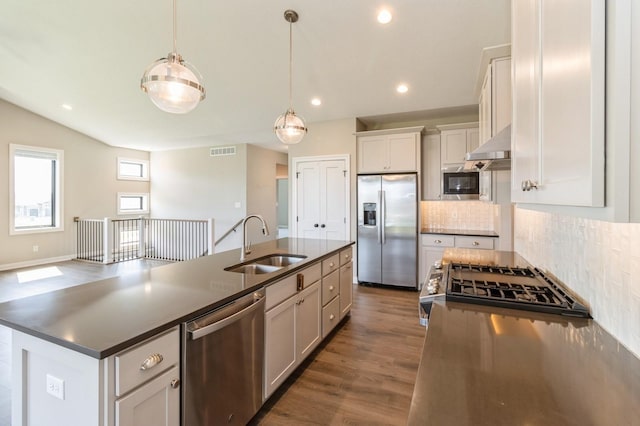 1809 12th St SE, Altoona, IA 50009 - kitchen featuring appliances with stainless steel finishes, dark countertops, backsplash, dark wood-style flooring, and recessed lighting