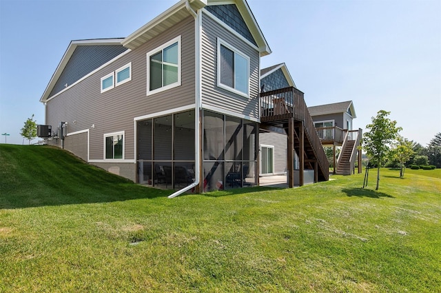 8932 Mockingbird Dr, West Des Moines, IA 50266 - rear view of house with stairway, a deck, a lawn, and a sunroom