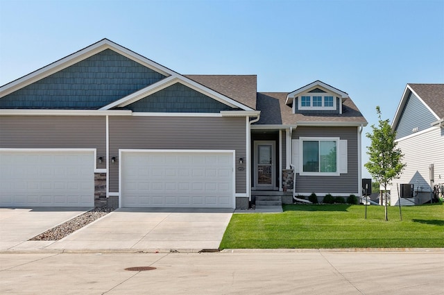 8932 Mockingbird Dr, West Des Moines, IA 50266 - craftsman house with driveway, a front lawn, and roof with shingles