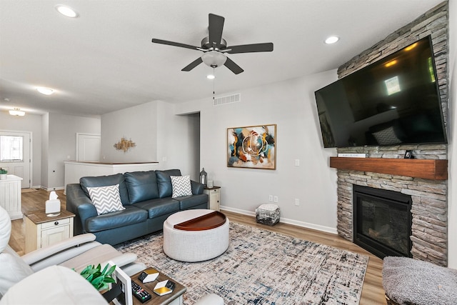8932 Mockingbird Dr, West Des Moines, IA 50266 - living room with ceiling fan, wood finished floors, a fireplace, and recessed lighting