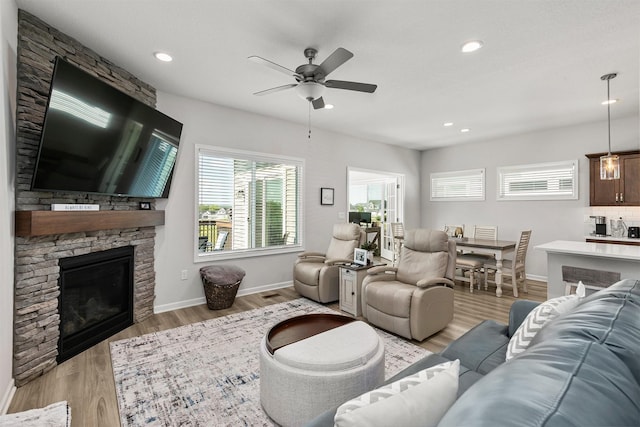 8932 Mockingbird Dr, West Des Moines, IA 50266 - living area with a fireplace, ceiling fan, light wood-style flooring, and recessed lighting