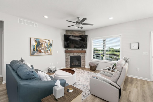 8932 Mockingbird Dr, West Des Moines, IA 50266 - living area featuring a ceiling fan, light wood-style flooring, a stone fireplace, and recessed lighting