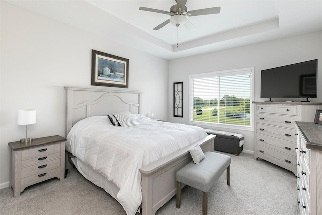 8932 Mockingbird Dr, West Des Moines, IA 50266 - bedroom featuring light carpet, a raised ceiling, and ceiling fan