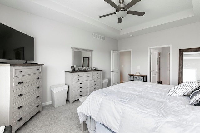 8932 Mockingbird Dr, West Des Moines, IA 50266 - bedroom featuring light colored carpet, a tray ceiling, and a ceiling fan