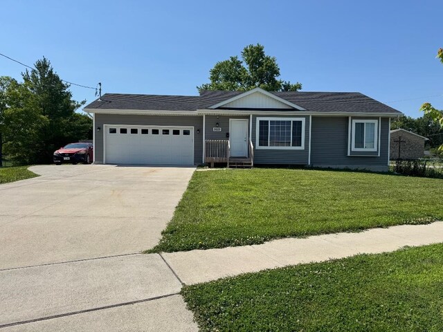 2625 Easton Blvd, Des Moines, IA 50317 - single story home featuring an attached garage, concrete driveway, and a front lawn