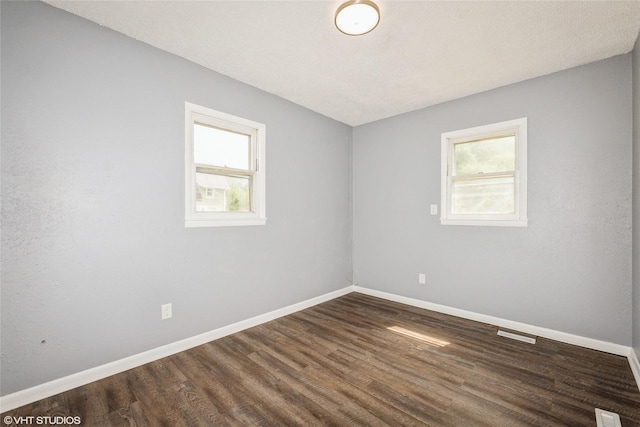 925 Laurel St, Des Moines, IA 50314 - empty room with plenty of natural light and dark wood-type flooring