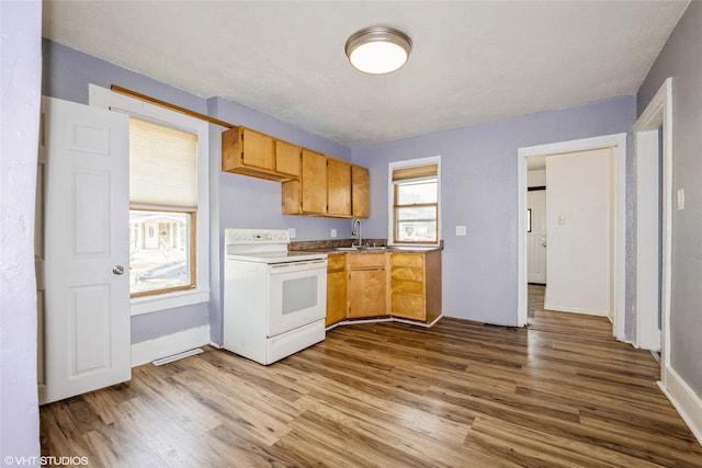 925 Laurel St, Des Moines, IA 50314 - kitchen with white electric stove and wood finished floors