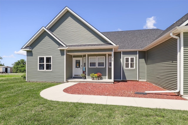 410 Sheridan St, Menlo, IA 50164 - view of front of property featuring a front lawn, a shingled roof, and covered porch