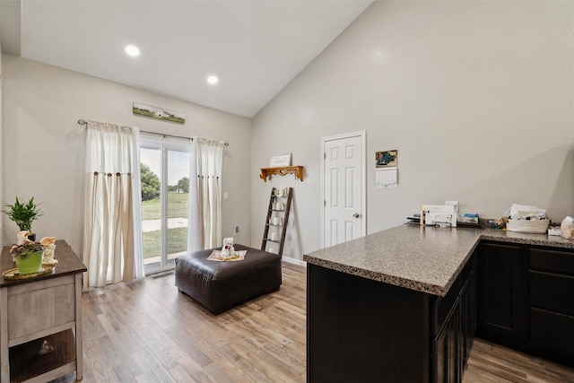 410 Sheridan St, Menlo, IA 50164 - kitchen featuring light wood-style flooring, high vaulted ceiling, dark cabinetry, recessed lighting, and a peninsula