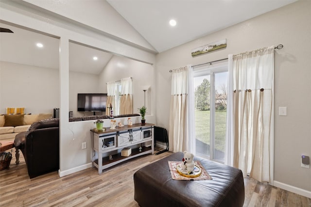 410 Sheridan St, Menlo, IA 50164 - living room with vaulted ceiling, plenty of natural light, light wood-style flooring, and recessed lighting