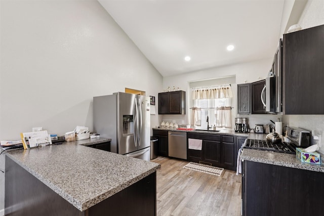 410 Sheridan St, Menlo, IA 50164 - kitchen featuring stainless steel appliances, light wood finished floors, a peninsula, high vaulted ceiling, and recessed lighting