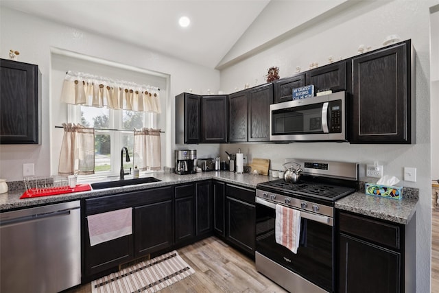 410 Sheridan St, Menlo, IA 50164 - kitchen featuring appliances with stainless steel finishes, lofted ceiling, light wood finished floors, dark cabinets, and recessed lighting