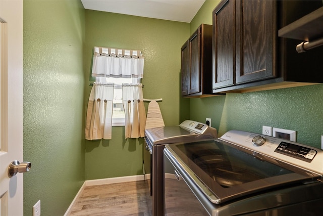 410 Sheridan St, Menlo, IA 50164 - washroom with washing machine and clothes dryer, cabinet space, wood finished floors, and a textured wall
