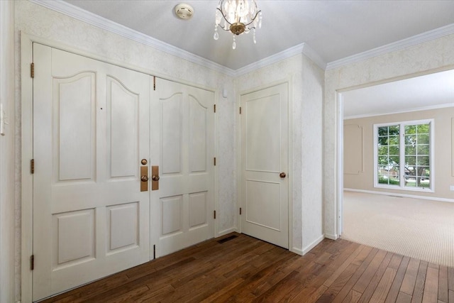 7819 Luin Ln, Windsor Heights, IA 50324 - entryway featuring a chandelier, dark wood finished floors, and ornamental molding